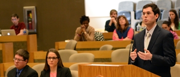 Students listening to a lecture in the law school's courtroom.