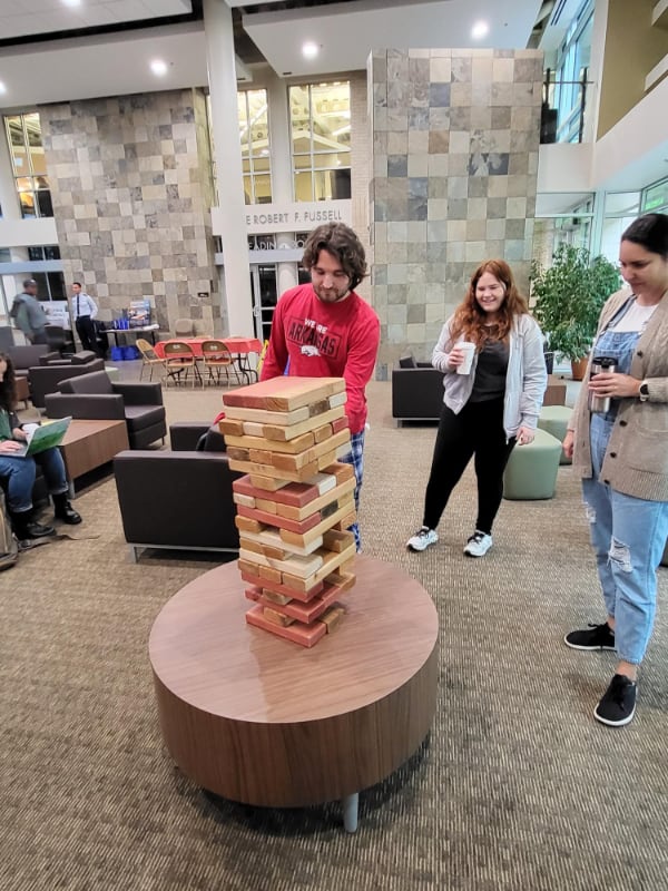 students playing giant jenga in the atrium.